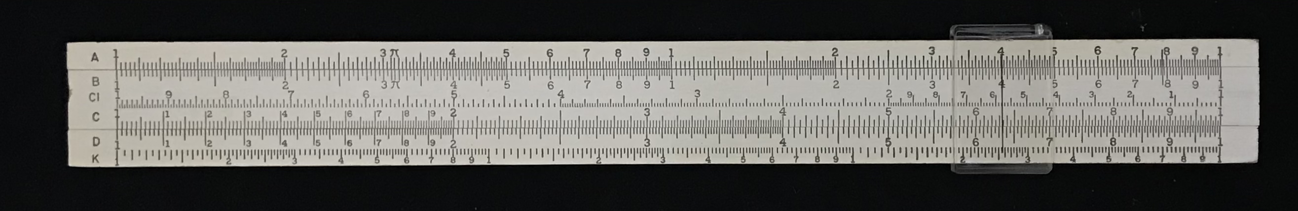 A K&E slide rule with K, A/B, and C/D scales (plus an inverted scale, CI).