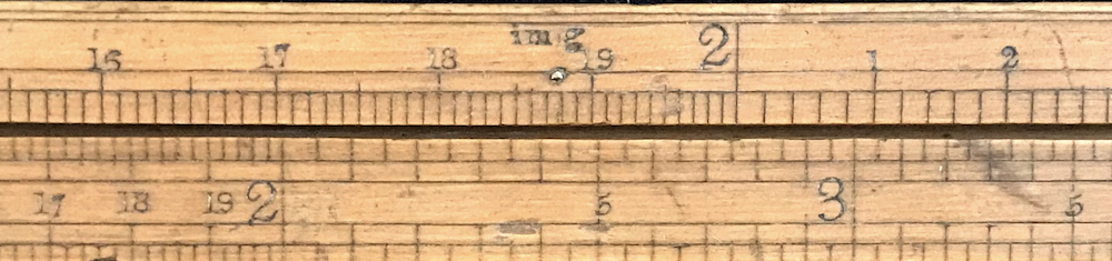 Close up of “im g” gauge mark with brass pin.